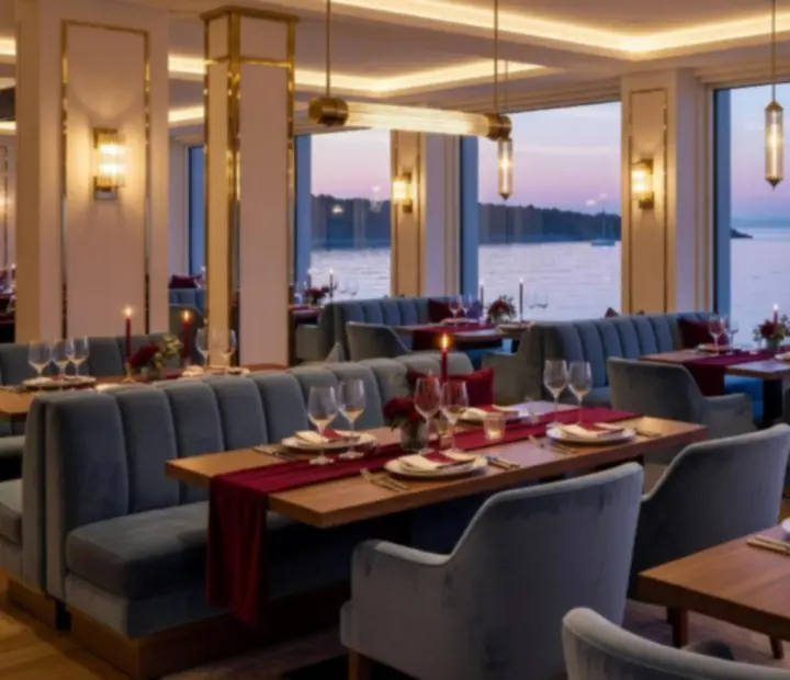 Harbourside restaurant interior with warm brass lighting and coastal-modern seating